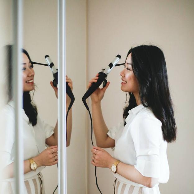Woman using a curling iron