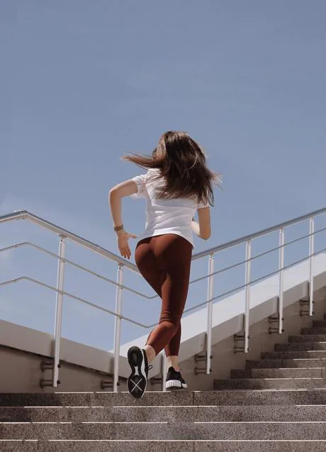 Woman climbing stairs/PEXELS