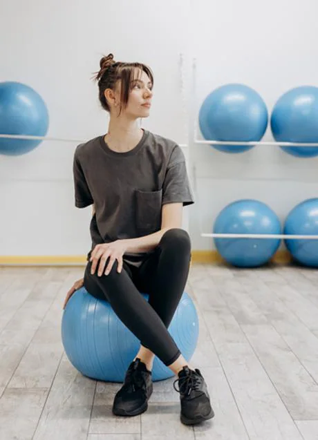 Woman sitting on stability ball/PEXELS